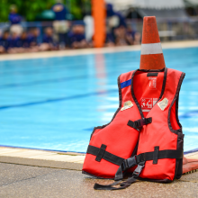 Life jacket placed infront of a pool.